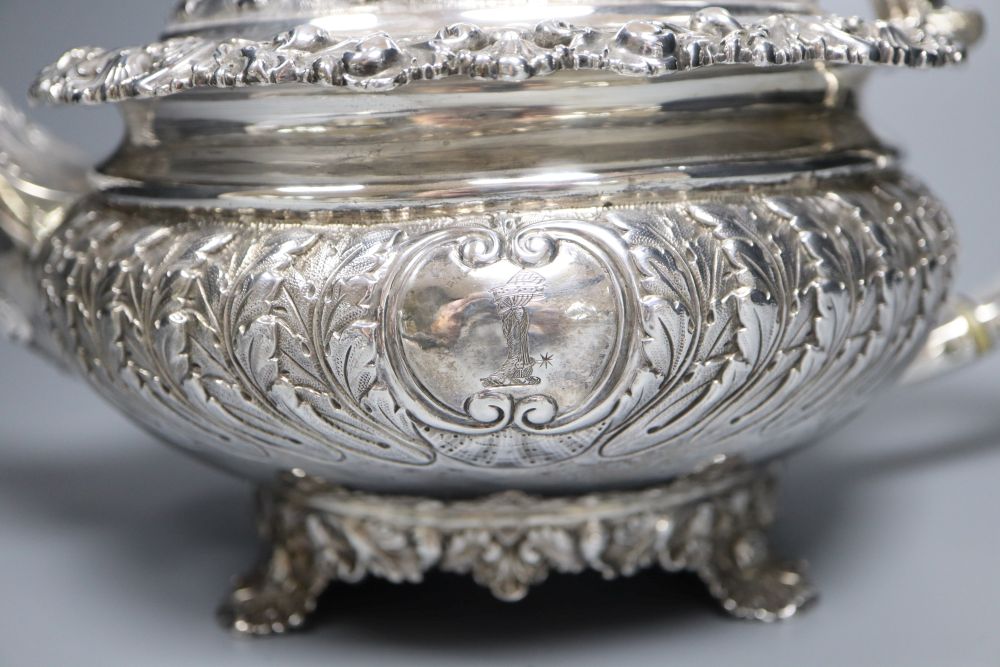 A George IV embossed silver squat circular teapot by Emes & Barnard, London, 1822,